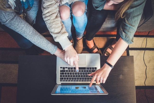 People collaborating at a computer